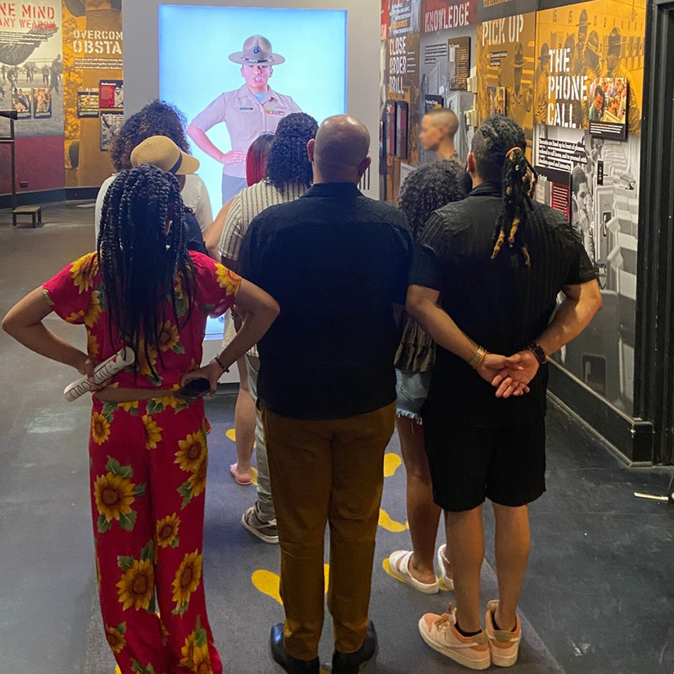 Visitors watching the Drill Instructor video presentation