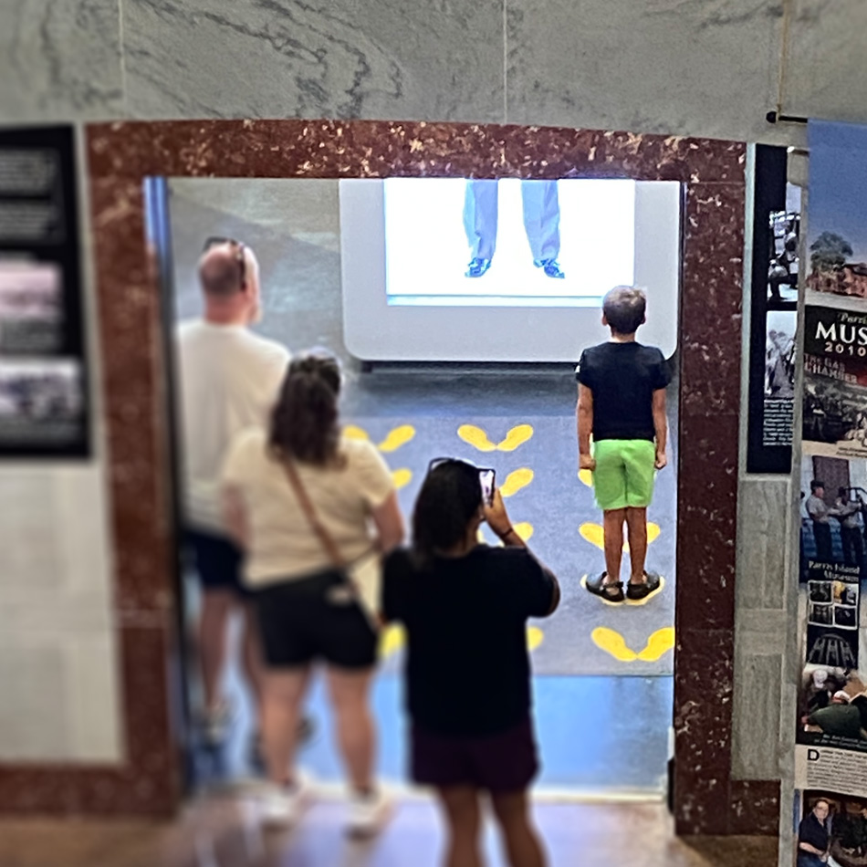 Family group interacting with the touchscreen kiosk