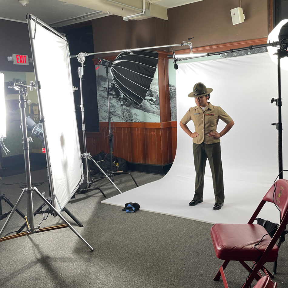 On-set film production of a USMC Drill Instructor against a white backdrop